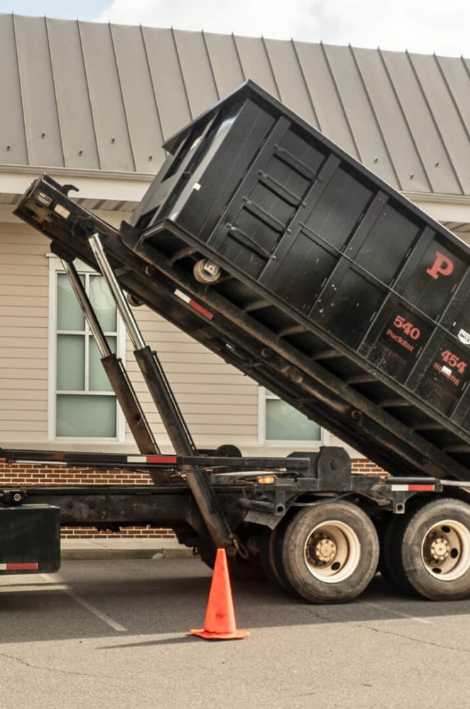 ACR Dumpsters delivering a dumpster in Lapeer County.